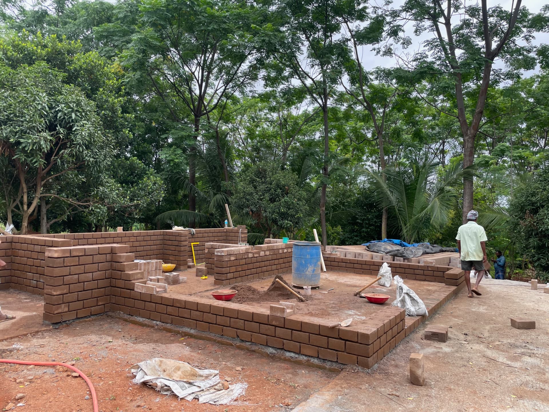 Brick walls rising from a concrete plinth at the start of the farmhouse build