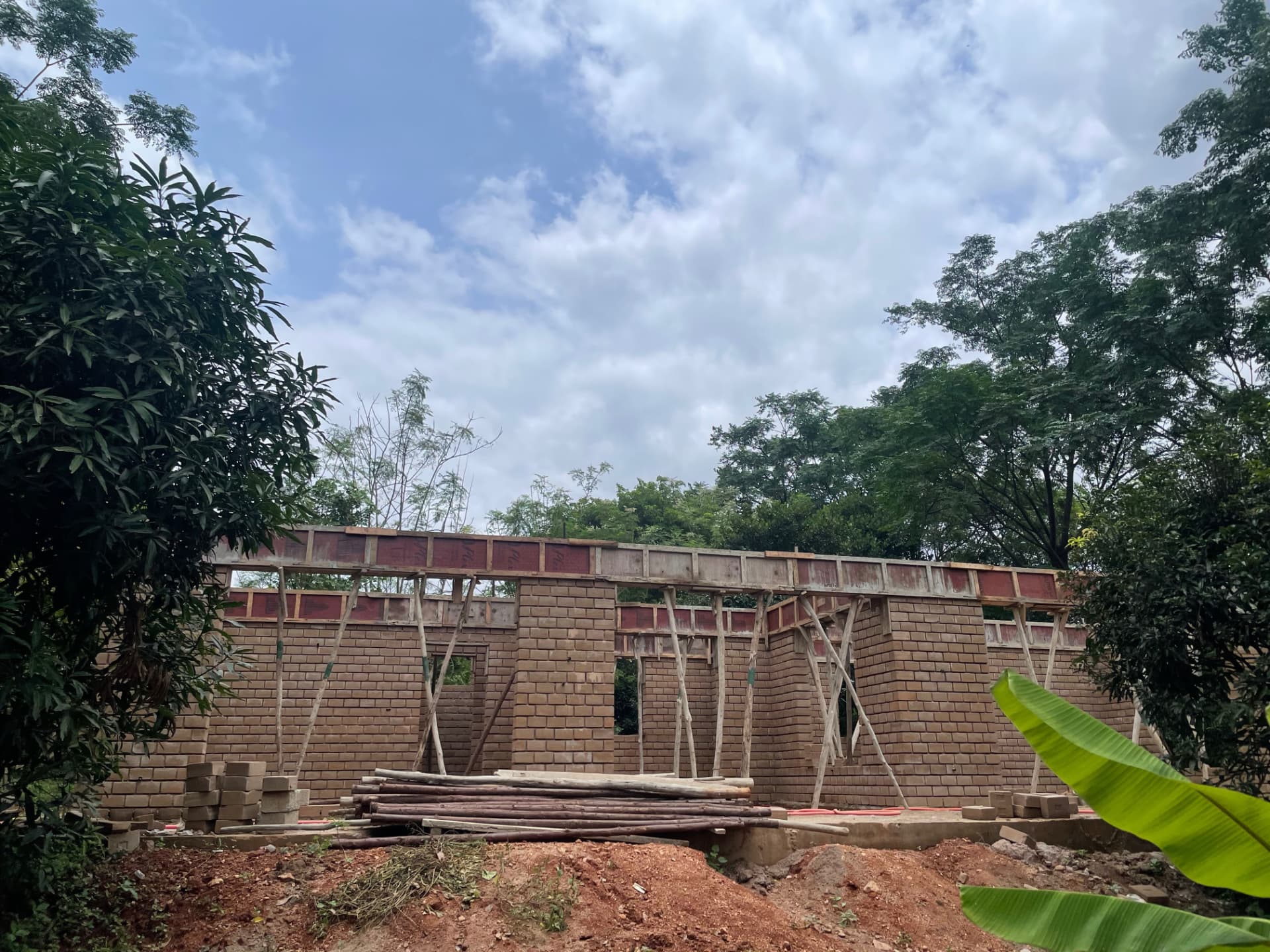 Farmhouse walls with timber props and shuttering ready for the roof beam